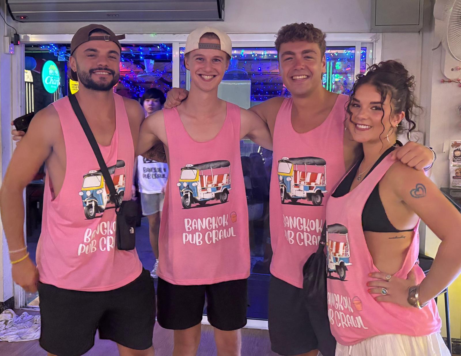 Pub crawl guests in pink tank tops meeting before the night starts
